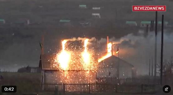 Still from a video said to show a Russian military exercise, with a drone-delivered thermite strike setting a building alight